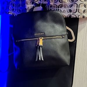 michael Kors back pack. new with tags balck with gold hard wear. front zipper,
